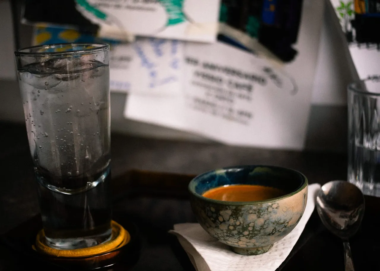 A small cup with espresso and a shot of sparkling water